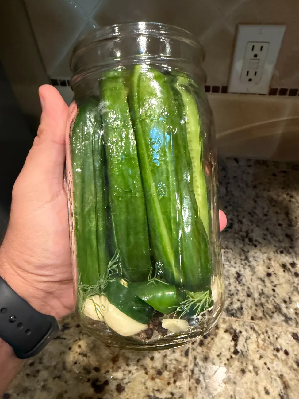 Photo of jalapeño-infused garlic pickles in a jar